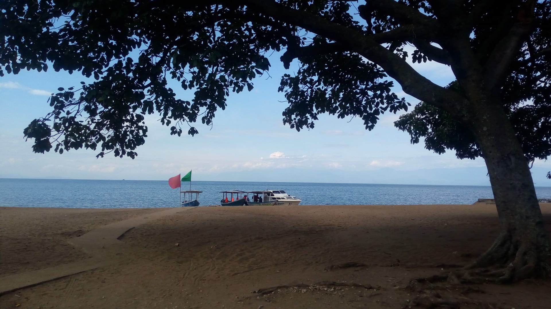 The Kivu shoreline under afternoon cloud